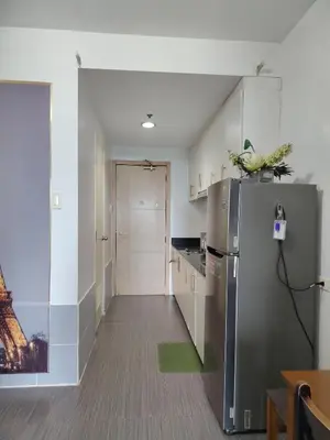 a kitchen with a stainless steel refrigerator at Sea Residences Feliz in Manila