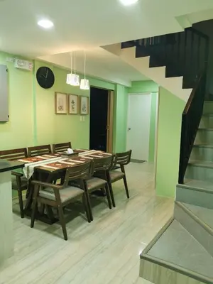 a dining room with a table and chairs and a staircase at Private Room Casa de los Reyes Kings' HouseHomestay in San Pedro