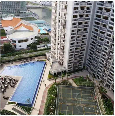 an aerial view of a large building with a swimming pool at Solemare Parksuites -Tower C in Manila