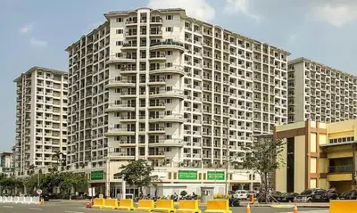 a large apartment building with a parking lot in front of it at Solemare Parksuites -Tower C in Manila