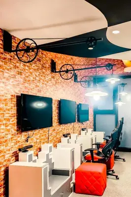 an office with a brick wall and desks and chairs at Designer Pad Town with Free Pool, Gym and Smart TV and Fast Wifi in Manila