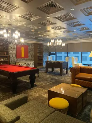 a living room with a pool table in the middle at Poblacion Makati with Pool, Gym, Jacuzzi, Pool Table and fast wifi in Manila