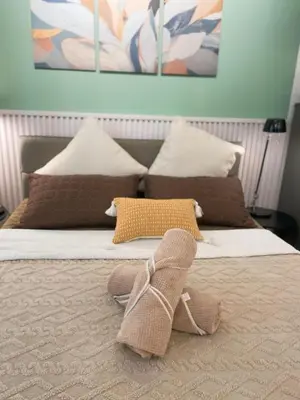a bed with two slippers on top of it at Venice McKinley Stay with Pool, Gym, fast Wifi and Netflix in Manila
