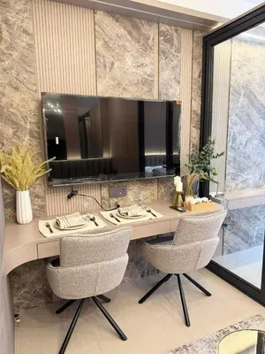 a desk with chairs and a large mirror on a wall at Harbor Calm Suite in Manila