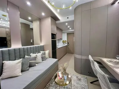 a living room with a couch and a dining room at Harbor Calm Suite in Manila