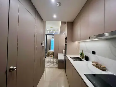 a small kitchen with a sink and a stove at Harbor Calm Suite in Manila
