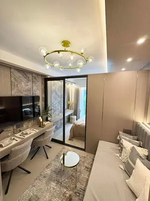 a living room with a chandelier and a desk at Harbor Calm Suite in Manila