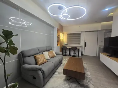 a living room with a couch and a table at The Sunset Suite at Torre 3916 in Manila