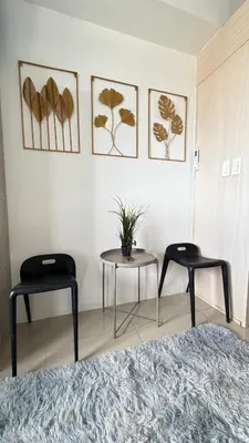two chairs and a table in a room at Jazz staycation makati by as in Manila