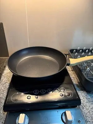 a frying pan on top of a stove at Uptown Home 1BR at One Uptown Residence BGC in Manila
