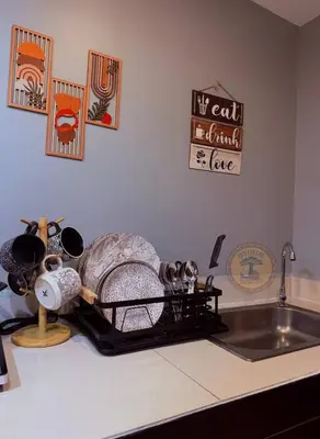a kitchen counter with a sink and a counter top with a counter at Cozy African Themed Unit in Parañaque in Manila