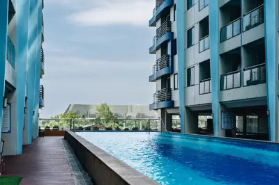 a swimming pool in the middle of two buildings at Dragon's Keep BNB near NAIA and MOA in Manila