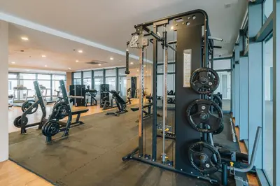 a gym with several treadmills and tread machines at Dragon's Keep BNB near NAIA and MOA in Manila