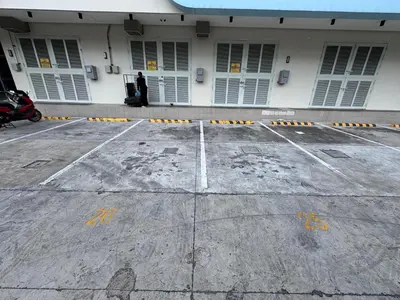 a man is standing outside of a building at Dragon's Keep BNB near NAIA and MOA in Manila