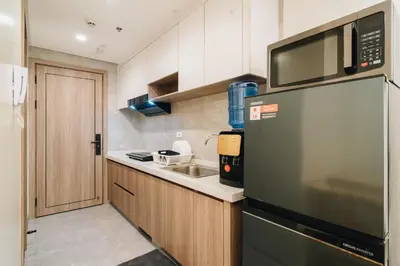 a kitchen with a refrigerator and a sink at Dragon's Keep BNB near NAIA and MOA in Manila