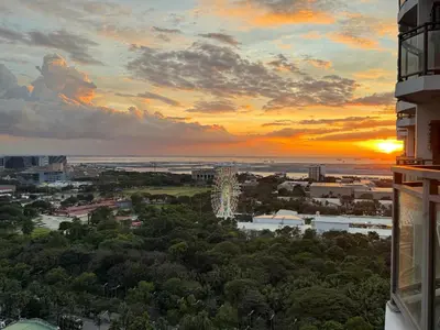 a view of a city at sunset from a building at Avelon Residence Hotel in Manila