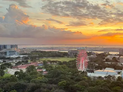 a city skyline with a ferris wheel at sunset at Avelon Residence Hotel in Manila