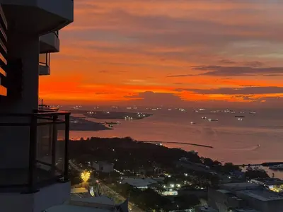 a view of the ocean at sunset from a building at Avelon Residence Hotel in Manila