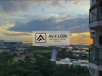 a sign for aevolution headquarters hotel in a city at Avelon Residence Hotel in Manila