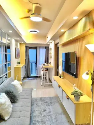 a living room with a couch and a tv at Hidden All in Comfy Luxe Stay MOA Pasay in Manila