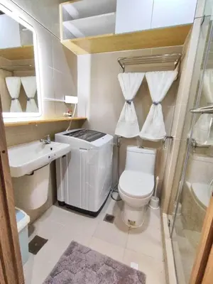 a bathroom with a toilet and a sink and a shower at Hidden All in Comfy Luxe Stay MOA Pasay in Manila