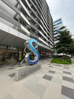 a large building with a s sign in front of it at Hidden All in Comfy Luxe Stay MOA Pasay in Manila
