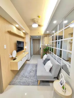 a living room with a couch and a tv at Hidden All in Comfy Luxe Stay MOA Pasay in Manila