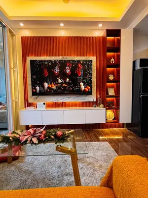 a fireplace in a living room with a fire place at Makati Staycation by Jing in Manila