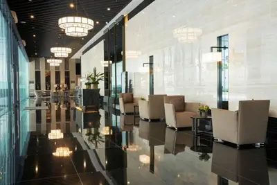 a lobby with chairs and tables in a building at Makati Staycation by Jing in Manila