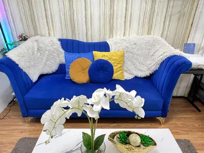 a blue couch with pillows on it in a living room at Shore 2 Near MOA Arena IKEA Okada in Manila