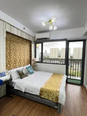 a bedroom with a large bed with a large window at Shore 2 Near MOA Arena IKEA Okada in Manila