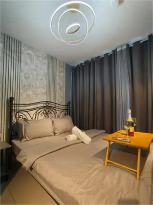 a bedroom with a bed with a table on it at Antel Spa & Serenity Suites by Yyess in Manila