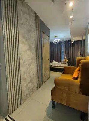 a living room with a couch and a bedroom at Antel Spa & Serenity Suites by Yyess in Manila