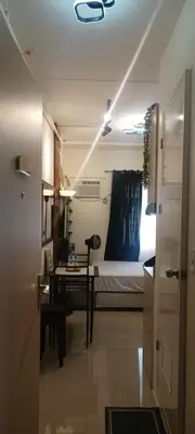 a room with a bed and a table and a desk at InMer's D Staycation in Manila