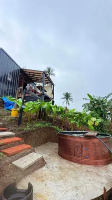 a house with a large tub in front of a building at Gamay Payag Tagaytay in Calamba