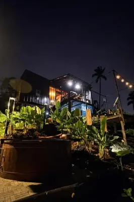 a house at night with plants in front of it at Gamay Payag Tagaytay in Calamba