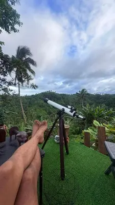 a man with his feet on a tripod with a telescope at Gamay Payag Tagaytay in Calamba