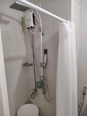 a bathroom with a shower with a toilet at Jazz Staycation Makati By As in Manila