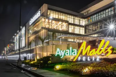 a large building with aania maliki sign in front of it at night at 1 Bedroom Apartment with Mountain View and WiFi in Manila