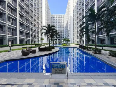 a large blue swimming pool in a city with tall buildings at City View Shore2 Residence Tower1 in Manila