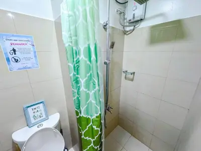 a shower curtain in a bathroom with a toilet at City View Shore2 Residence Tower1 in Manila