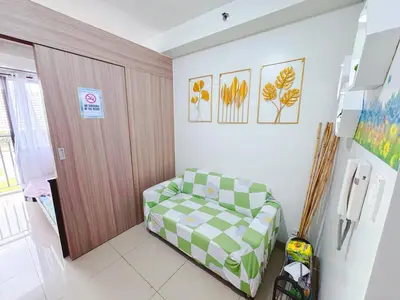 a room with a green and white couch in a room at City View Shore2 Residence Tower1 in Manila