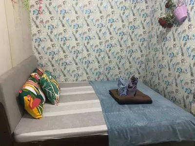 a small bed with a figurine sitting on top of it at Suite hotel at Mall of Asia - Tes Ualat in Manila