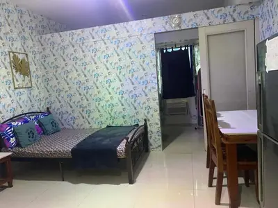 a room with a bed and a table and a dining room at Suite hotel at Mall of Asia - Tes Ualat in Manila