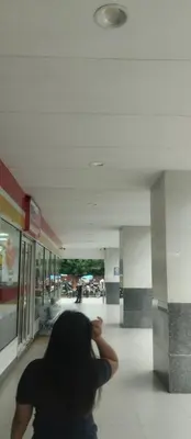 a person is standing in a hallway in a mall at Suite hotel at Mall of Asia - Tes Ualat in Manila