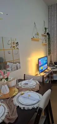 a table with plates on it with a computer in a room at Villa Felize Homestay at Torre de Manila in Manila