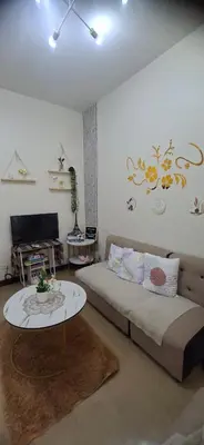 a bedroom with a bed and a table in it at Villa Felize Homestay at Torre de Manila in Manila