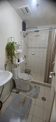 a bathroom with a toilet and a sink and a shower at Villa Felize Homestay at Torre de Manila in Manila