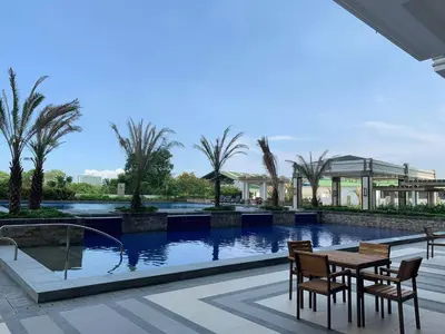 a patio with a table and chairs next to a pool at Villa Felize Homestay at Torre de Manila in Manila