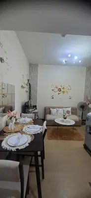 a living room with a table and a couch at Villa Felize Homestay at Torre de Manila in Manila